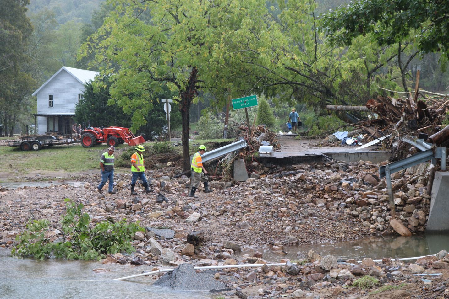 Workers assess damage following storm damage from Hurricane Helene.