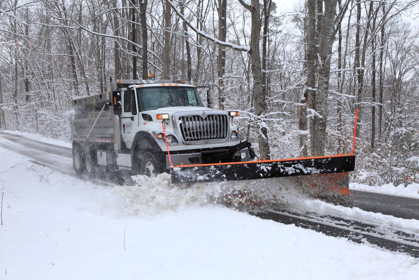 Virginia Department of Transportation snow plow making a snow-covered road passable