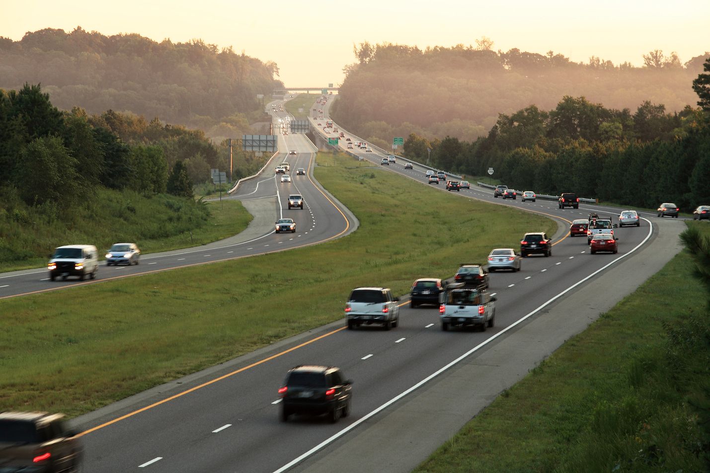 Cars traveling on interstate in rural landscape