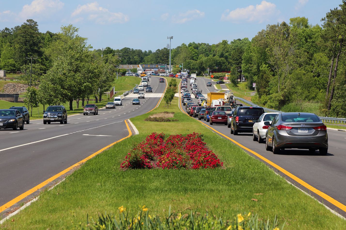 Cars traveling in opposite directions with grassy median separating them
