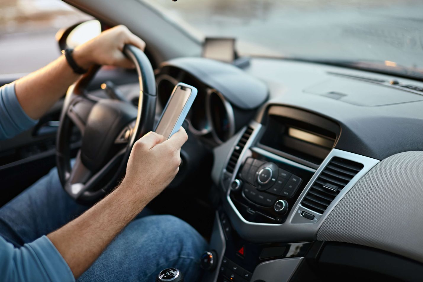 distracted driver with phone in hand