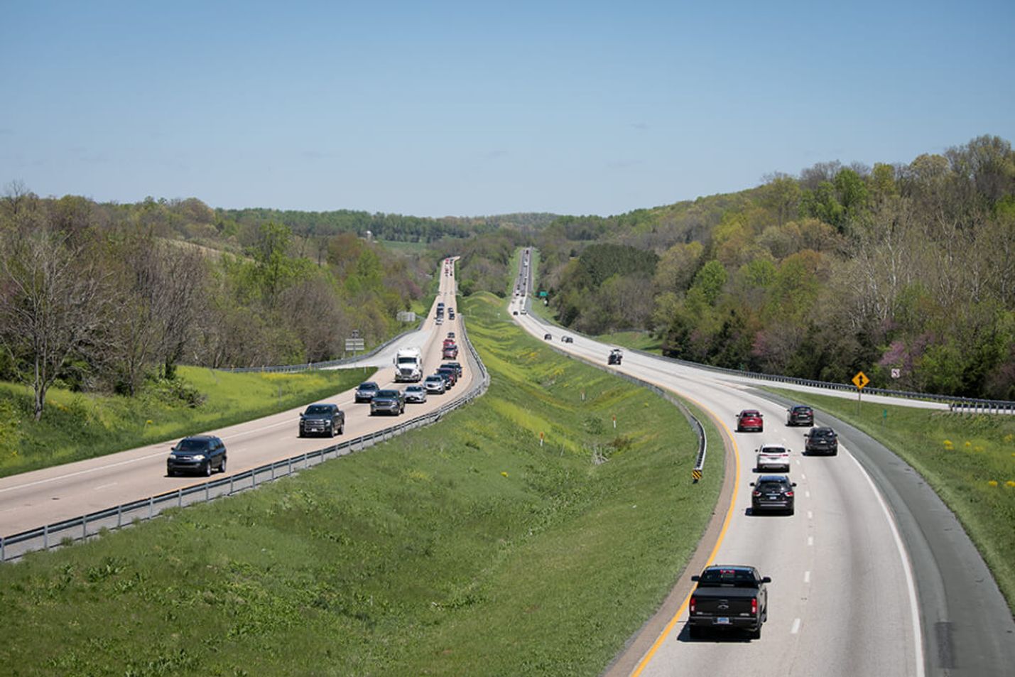 Numerous vehicles driving down a multi-lane highway