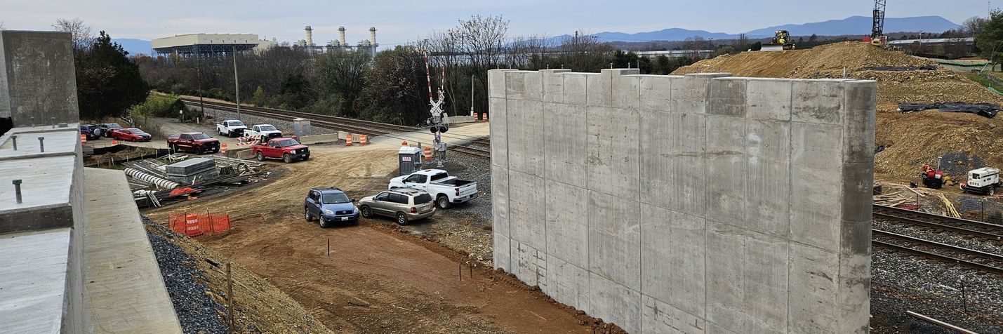 Construction site with heavy equipment and unfinished bridge piers