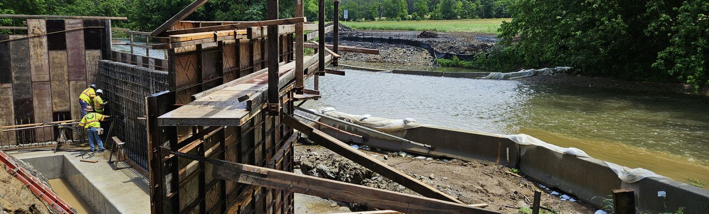 Cofferdams and construction crews working on a new river bridge