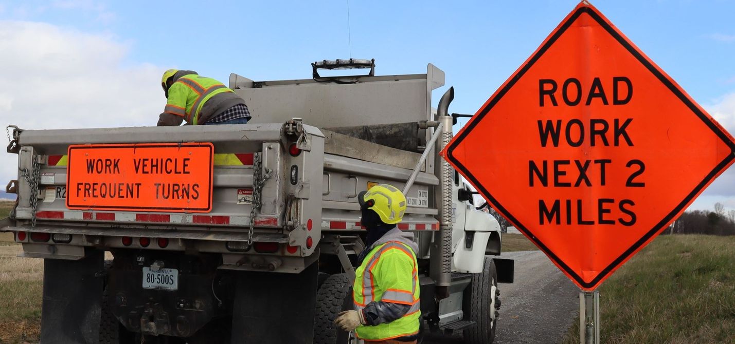 Crew Setting up Road Work signs