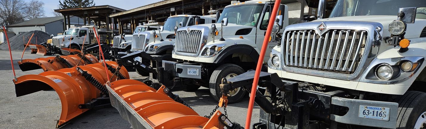 Snow plows in a row are ready to deploy from VDOT's Fairfield Area Headquarters.
