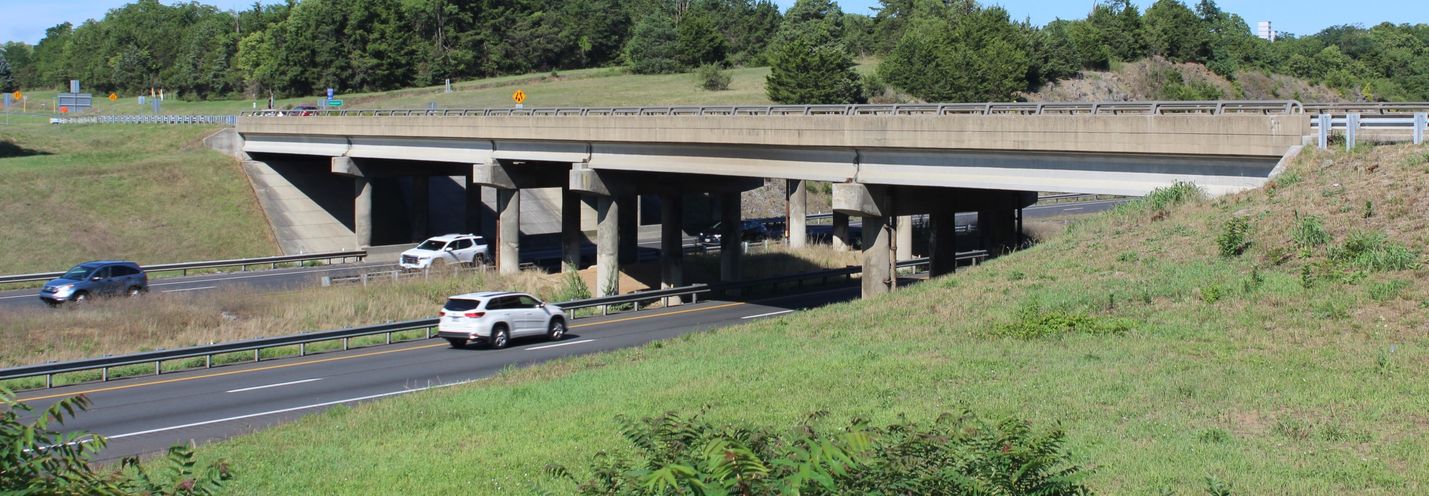 Interstate traffic passing under a bridge on a sunny summer day