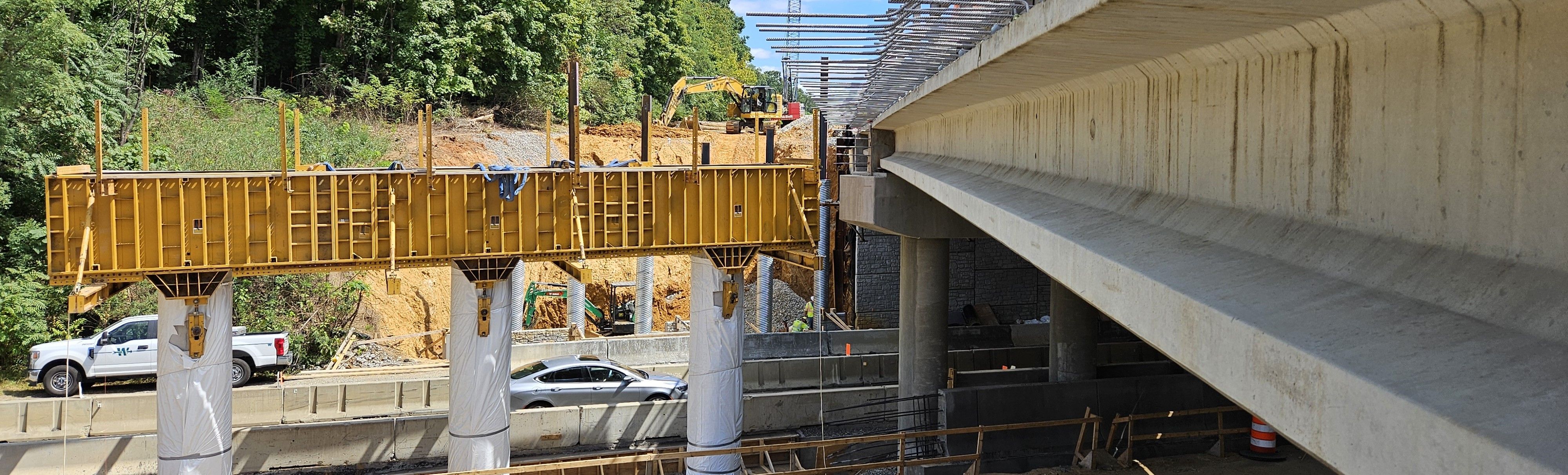 Construction of a new bridge, with traffic going by underneath