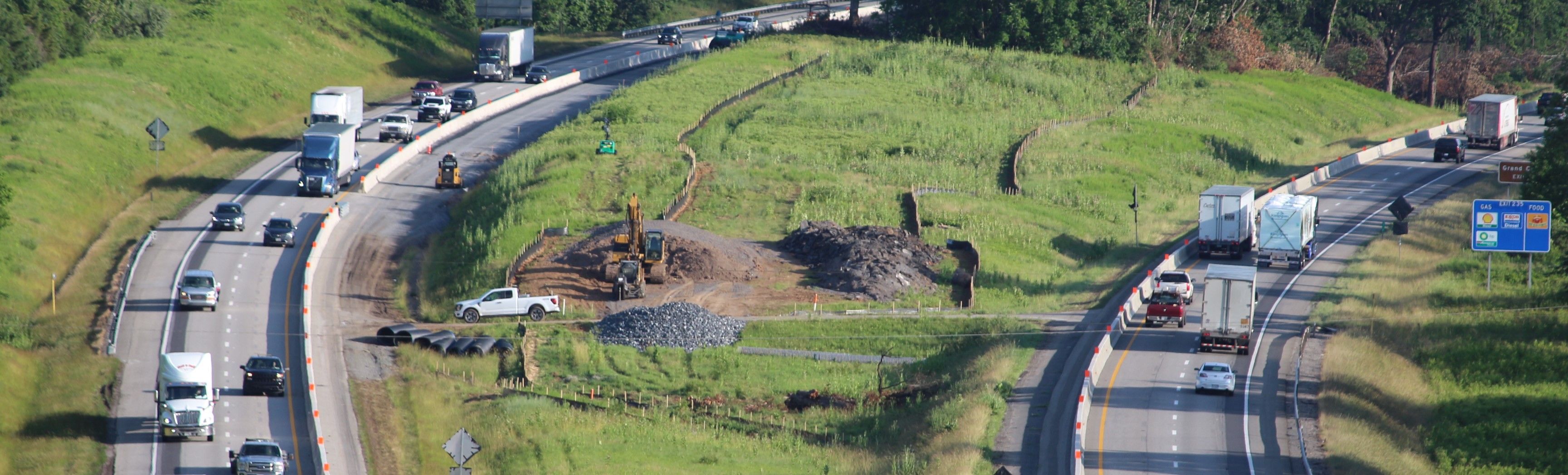 Elevated view of a four-lane divided highway with a work zone in the median