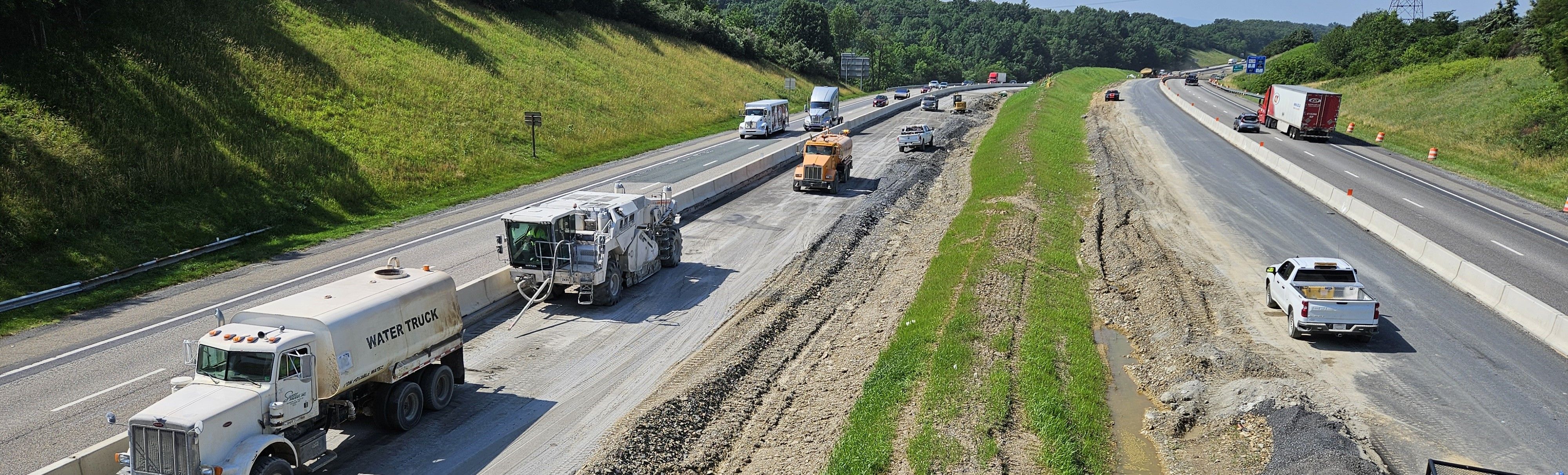 Elevated view of a four-lane divided highway with a work zone in the median
